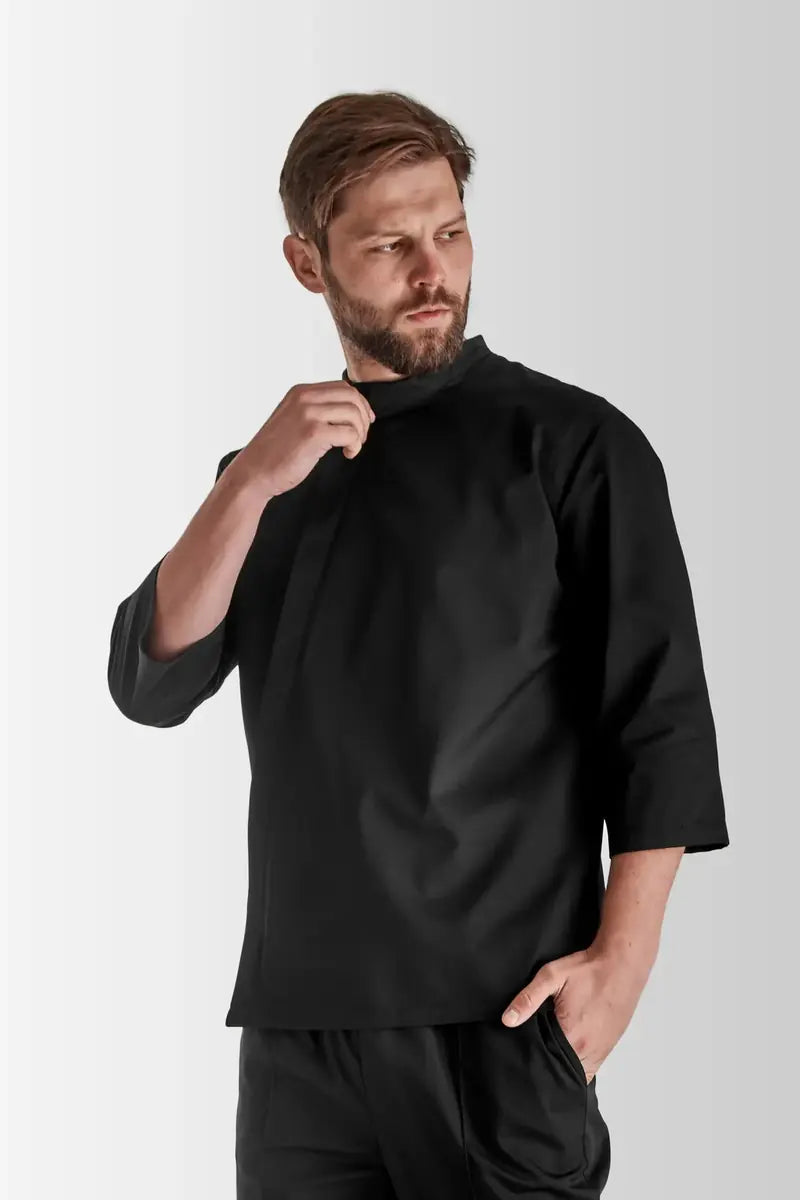 Male chef wearing a black VSETEX chef jacket