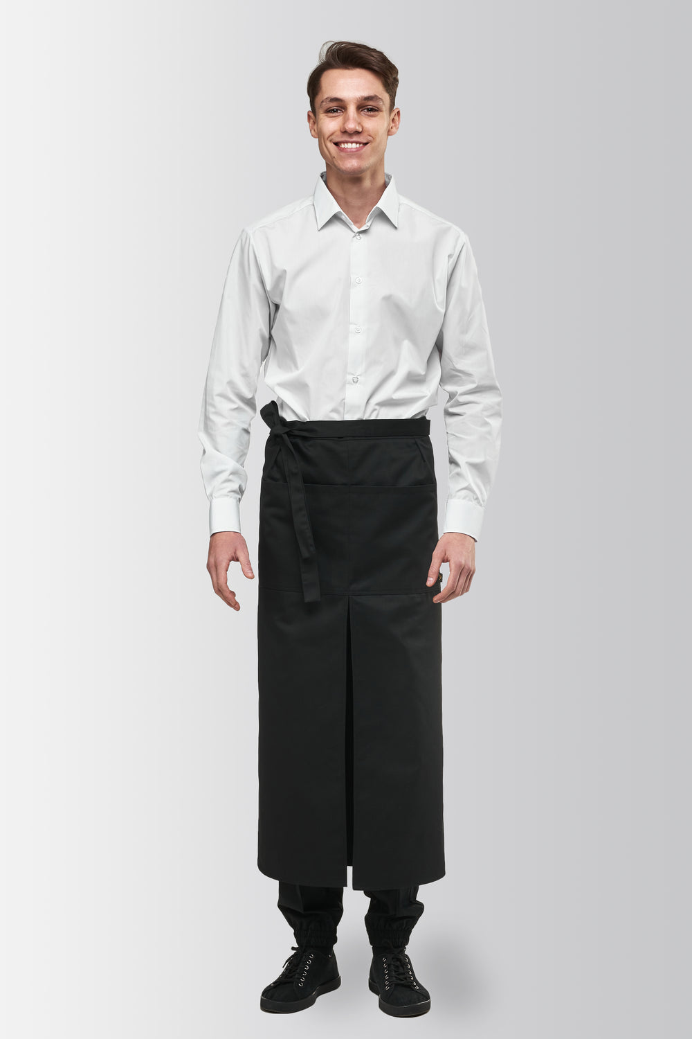 Black long bistro apron worn by a male model, front view