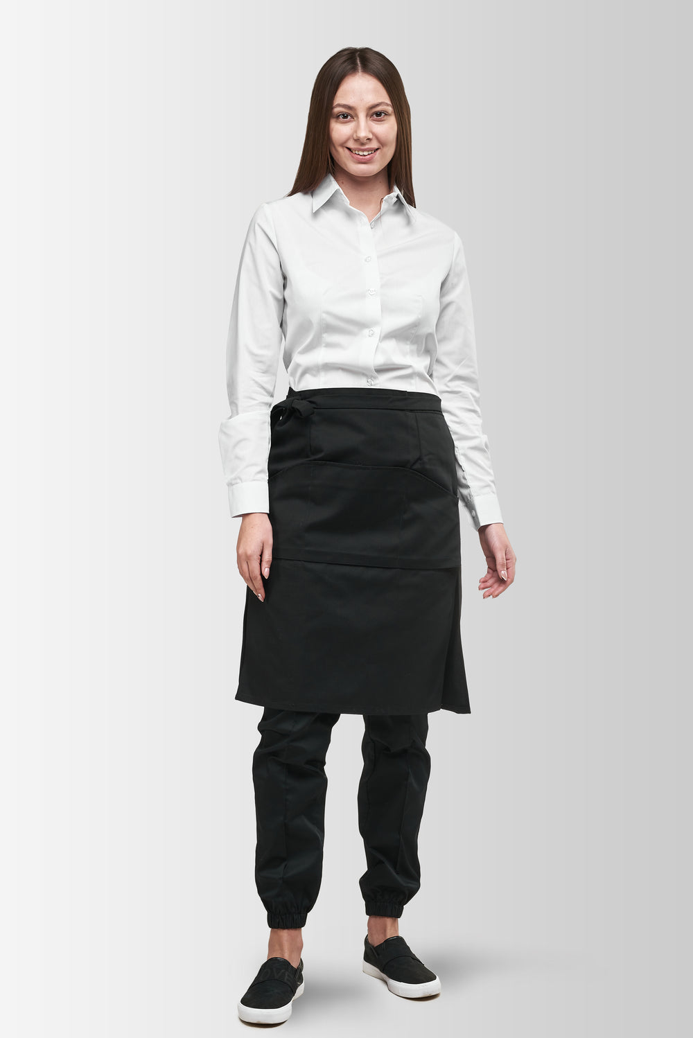 Black Tiramisu waist apron worn by a female model, front view