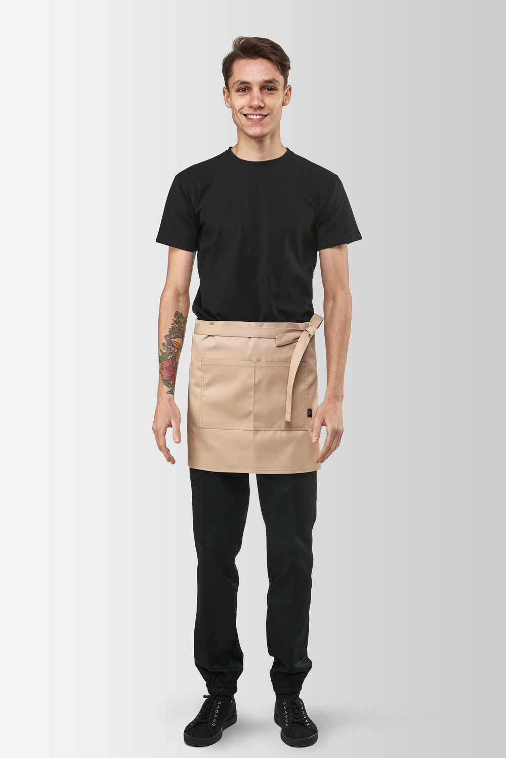 Beige Berry short waist apron worn by a male model, front view