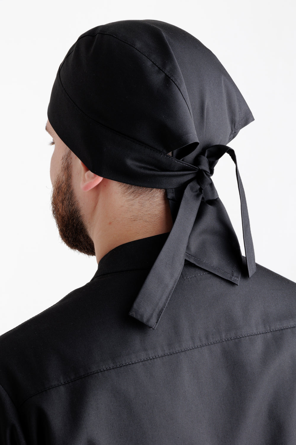 Black chef bandana styled with a black chef coat and pants, full-length view