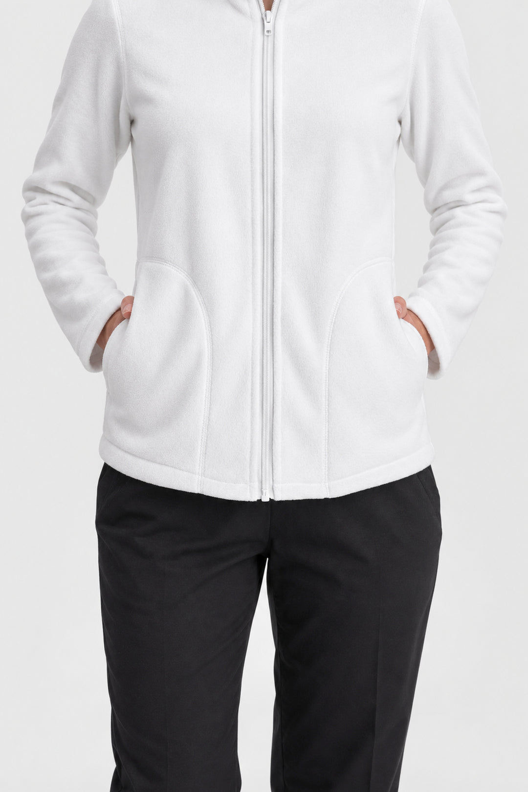 A person wearing a white zip-front fleece jacket with front pockets, paired with black pants, shown against a light gray studio background.