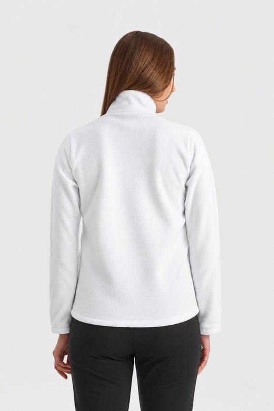 A woman viewed from the back wearing a white long-sleeve mock-neck fleece jacket and black pants, set against a plain light gray studio background.