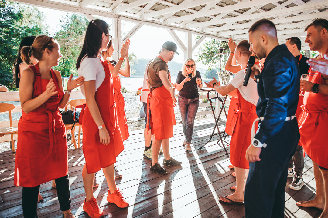 Group wearing matching red bib aprons during a team event