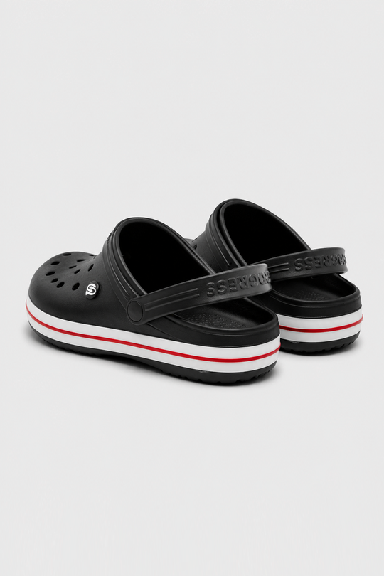 A pair of black Croc-style clogs with a white midsole stripe and a thin red accent line, photographed on a light gray background.
