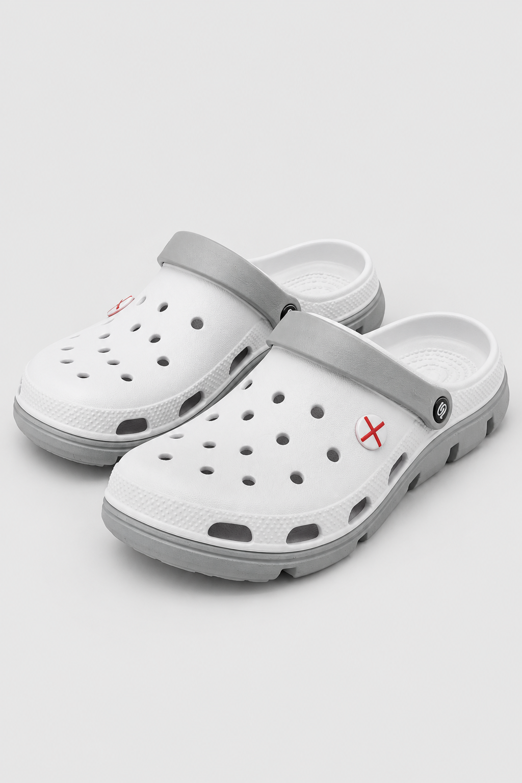 A pair of white and gray clog-style sandals with small red cross logos on the side, displayed on a light gray background.